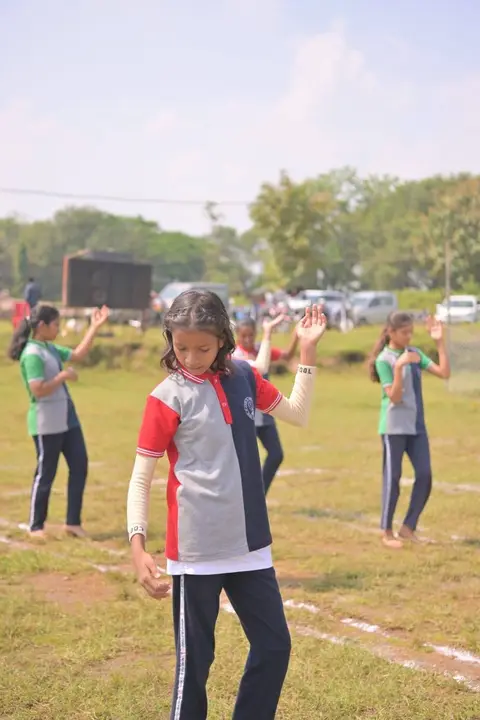 A Kho-Kho player mid-chase on the school ground