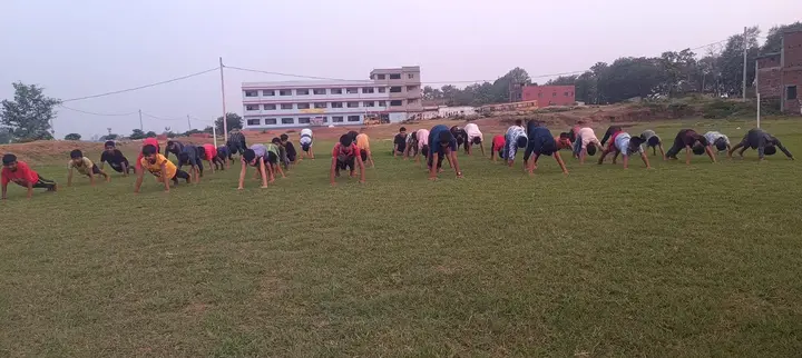 Students stretch during practice for International Yoga Day